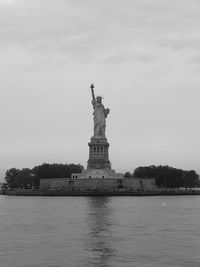 Statue of liberty against cloudy sky