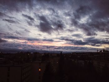 Cloudy sky above city at sunset