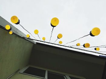 Low angle view of balloons against sky