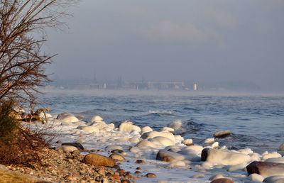 Scenic view of sea against sky during winter