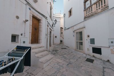 Empty alley amidst buildings in city