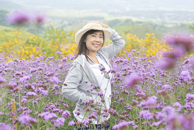 Portrait of smiling woman standing on field