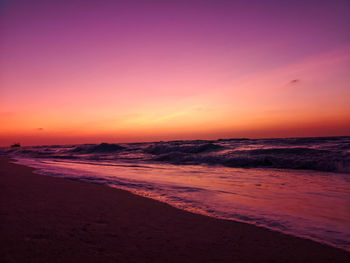 Scenic view of beach against sky during sunset