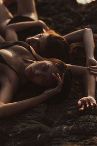 High angle view of woman laying on rock