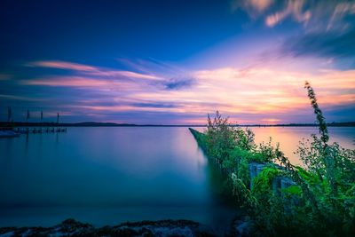 Scenic view of lake against sky during sunset