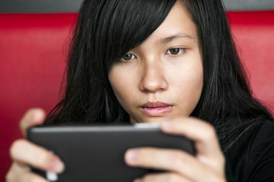 Portrait of young woman using phone