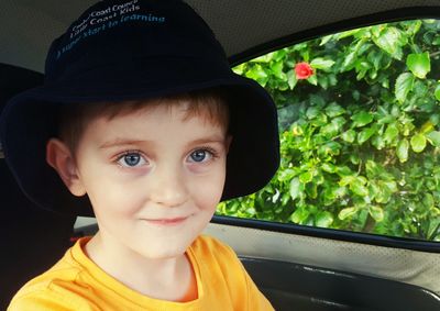 Portrait of cute boy in car