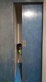 Rear view of woman standing in corridor