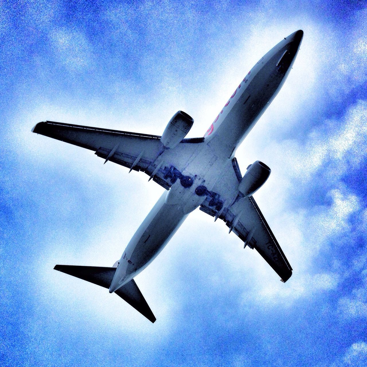 flying, airplane, low angle view, blue, mid-air, air vehicle, sky, transportation, mode of transport, aircraft wing, cloud - sky, on the move, travel, cloud, flight, spread wings, motion, aircraft, airways, day