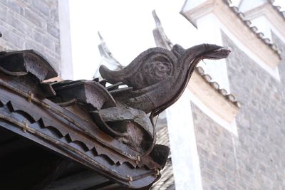 Low angle view of statue on roof