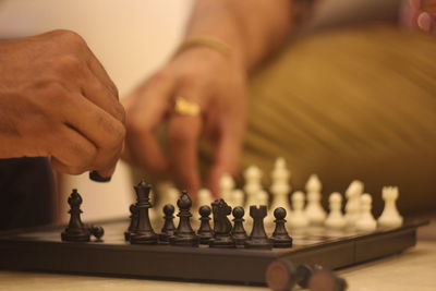 Low angle view of people playing on chess board