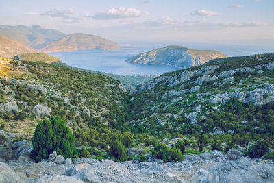 Scenic view of sea and mountains against sky