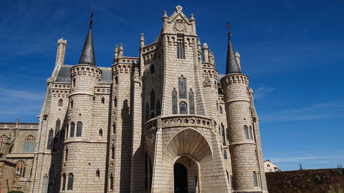 Low angle view of historical building against blue sky