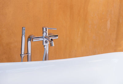 Close-up of faucet in bathroom