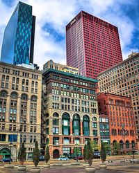 Buildings against cloudy sky