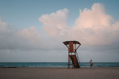 Lifeguard hut on beach against sky