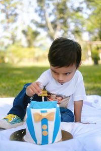 Side view of girl playing with toy on bed at park