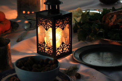 Close-up of illuminated candles on table