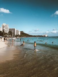 People on beach against sky