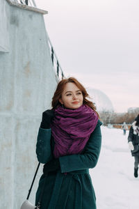 Portrait of woman standing in snow