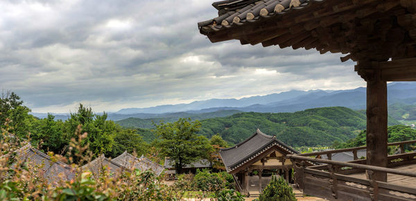 View of houses against cloudy sky