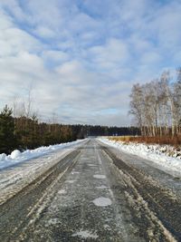 Surface level of road against sky during winter