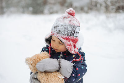 Girl with toy in snow