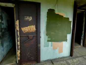 Graffiti on old door of abandoned building