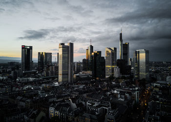 View of cityscape against cloudy sky