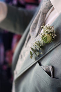 Midsection of woman holding flower