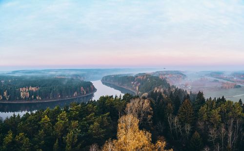 High angle view of river and trees against sky