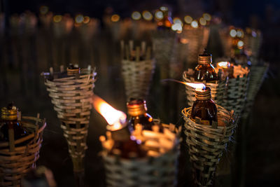 Close-up of lit candles in basket