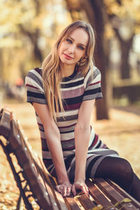 Portrait of young woman playing guitar