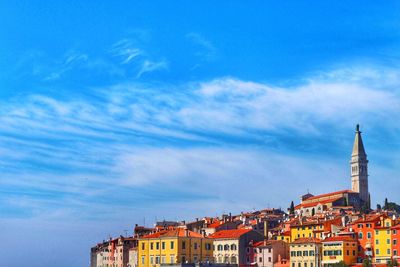 View of cityscape against cloudy sky