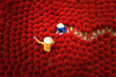 High angle view of women holding incense sticks 