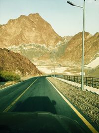 Empty road leading towards mountains