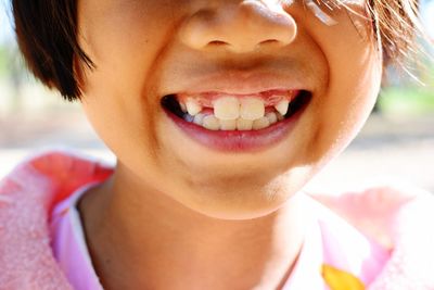 Close-up midsection of smiling girl showing teeth