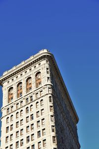 Low angle view of building against blue sky