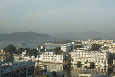 High angle view of river by buildings against sky