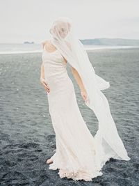 Full length of woman standing on beach