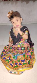 Portrait of cute girl sitting on floor at home