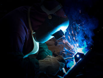 Side view of man working in factory