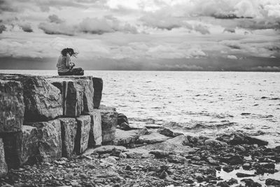 Scenic view of rocks on beach against sky