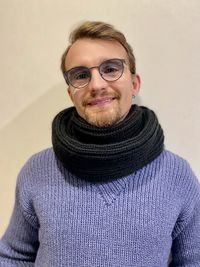 Portrait of smiling man standing against wall