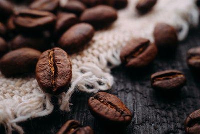 Close-up of roasted coffee beans on table