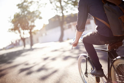 Low section of man riding bicycle
