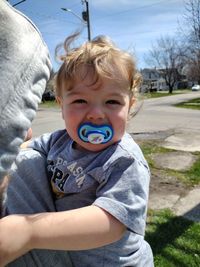 Portrait of young man with a pacifier. 