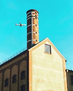 Low angle view of old building against clear blue sky