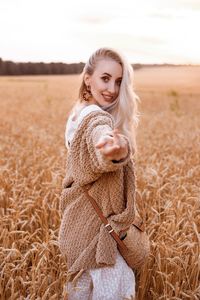 Side view of young woman standing at farm
