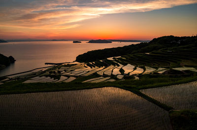 Scenic view of doya rice terrace against sky during sunset